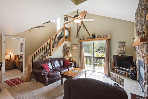 Living room with entry to downstairs bed and bath.
