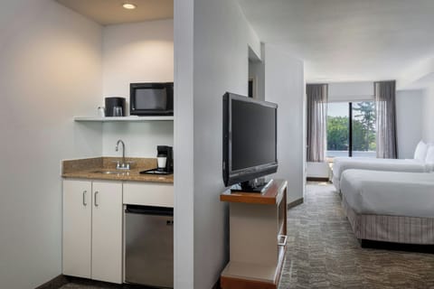 Premium bedding, desk, laptop workspace, blackout drapes