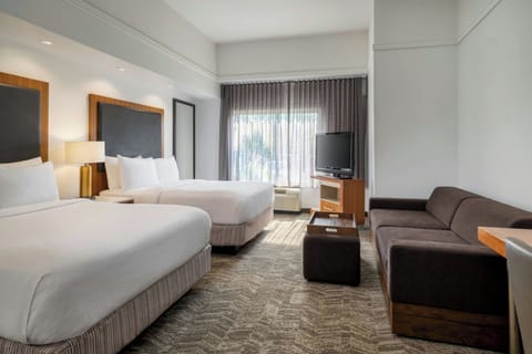 Premium bedding, desk, laptop workspace, blackout drapes