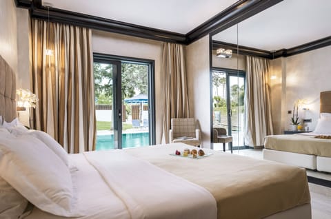 Twin Room (Sharing Pool) | Minibar, in-room safe, desk, blackout drapes