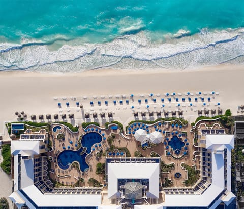 On the beach, white sand, beach cabanas, sun loungers