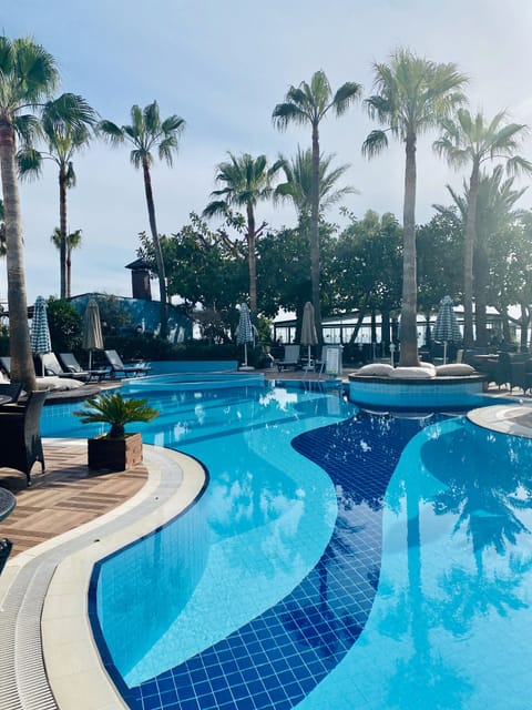 Seasonal outdoor pool, pool umbrellas, sun loungers