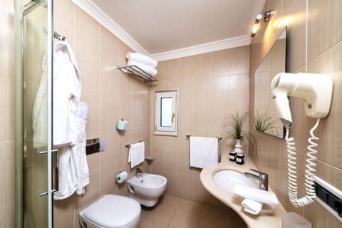 Eco-friendly toiletries, slippers, bidet, towels