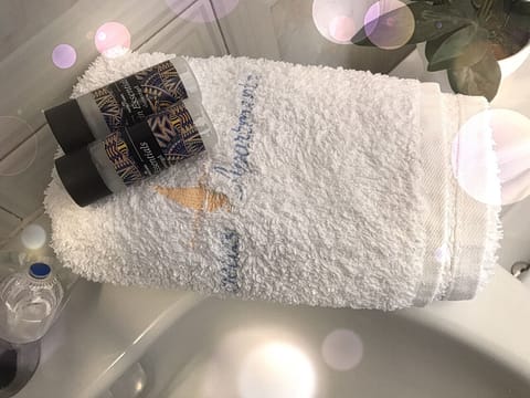 Shower, designer toiletries, hair dryer, towels