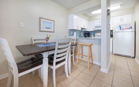 The kitchenand dining area features sleek cabinetry, a table for four, and a cozy atmosphere perfect for family meals