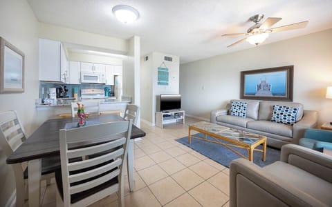 This inviting living area features a cozy couch, a TV, and a dining table, perfect for relaxing after a day of fun