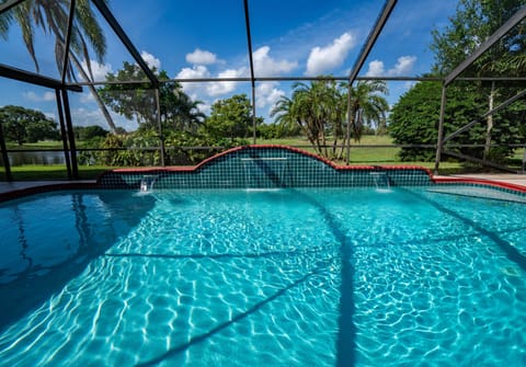 HUGE 30’x15’ heated cascade swimming pool facing the manicured golf course.