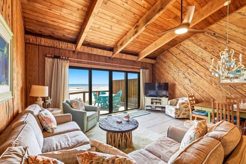 Coastal living room for everyone to enjoy, also direct access to the balcony featuring beautiful ocean views.