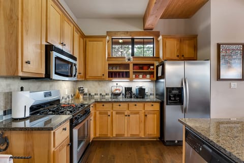 Full stocked kitchen with microwave, gas oven, large granite island with sink.