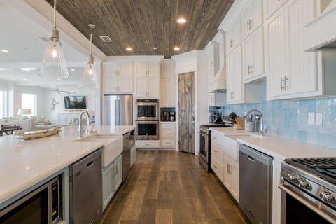 Kitchen with 3 dishwashers, 3 full size refrigerators, 2 gas range cook tops and and 4 ovens.