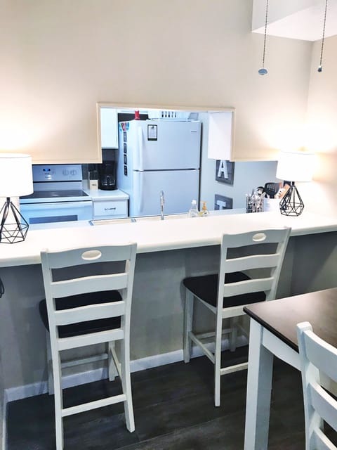 Dining view into kitchen; has an eat in area counter