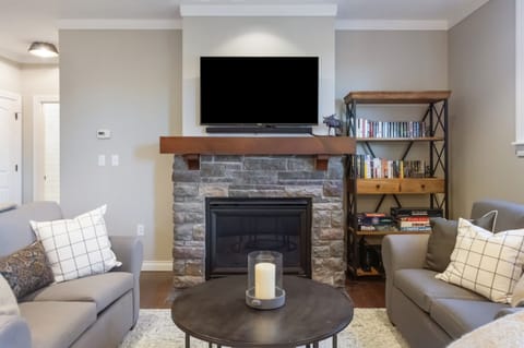 - Cozy living room with stone fireplace and smart TV for relaxing evenings   - Plush seating and natural light create a warm mountain vibe   - Perfect spot for streaming, reading, or board game nights