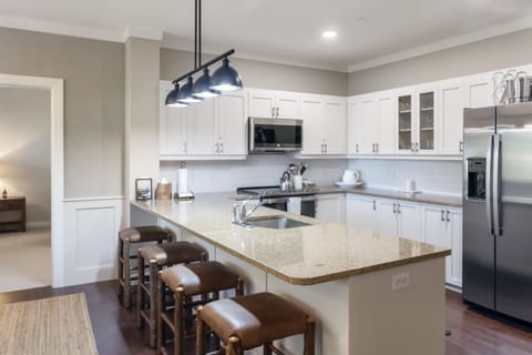- Large kitchen island with bar seating for casual dining   - Open-concept layout connects to living and dining spaces   - Perfect for breakfast gatherings and social cooking
