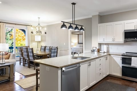 - Modern kitchen with stainless steel appliances and granite counters   - Open layout connects to dining and living areas for easy entertaining   - Fully equipped for family meals and après-ski gatherings