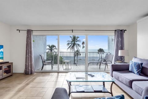 Comfortable living room with modern seating, natural light, and an open layout — ideal for relaxing during your Sarasota beach stay.