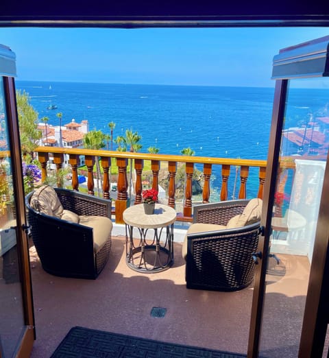 - Slide open the doors and step into a cozy seaside haven with front row ocean views
- Plush chairs and a stone bistro table invite sunset wine or sunrise coffee
- Gaze out over sailboats and palms, your private paradise awaits