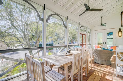 Relax on your screened porch with elegant dining space and cozy seating, where filtered sunlight creates perfect ambiance.