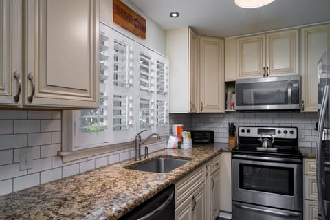 The kitchen has been updated with granite counters and custom cabinets.