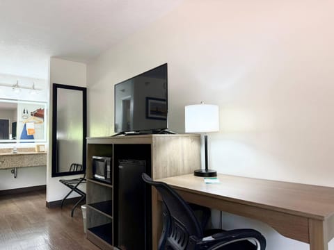 Premium bedding, desk, laptop workspace, blackout drapes