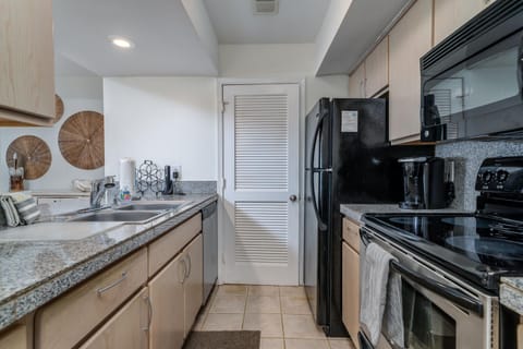 Well appointed kitchen with stack washer and dryer in the pantry
