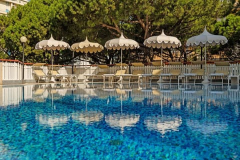 Outdoor pool, open 8:00 AM to 7:00 PM, pool umbrellas, sun loungers