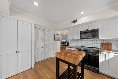The laundry is tucked behind louvered doors in the kitchen