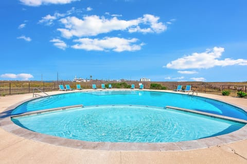 Sparkling rooftop pool with panoramic city views and comfortable lounge chairs awaiting your perfect poolside relaxation.