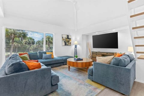 Walk in the front door to the open floor plan. Enjoy the open living area. This bright home has hardwood floors and an inviting blue and white decor.  Dining area with sliding doors that lead to the deck with table and chairs.