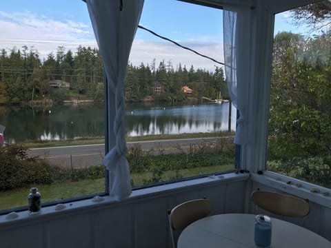 The enclosed front porch overlooking Mystery Bay is a guest favorite. 