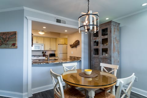 The dining table with seating for four (plus 2) sits just off the kitchen