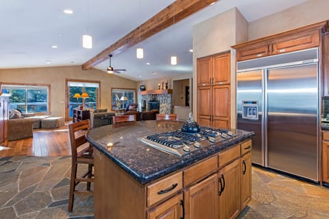 Center island, 5 burner cook top, seating for 4 looking out to the great room