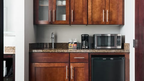 Microwave, coffee/tea maker, cleaning supplies, freezer