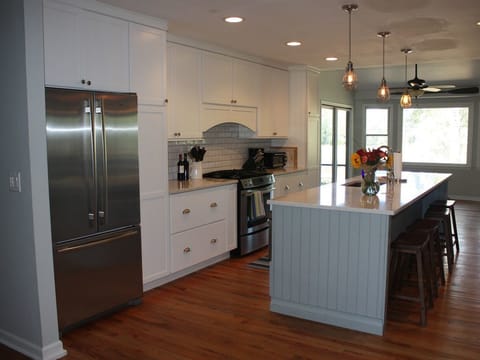 Newly remodeled kitchen with large 10ft island, stainless steel appliances.