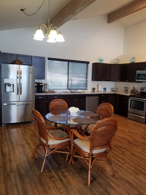 Dining table, vaulted ceilings and spacious modern kitchen. 