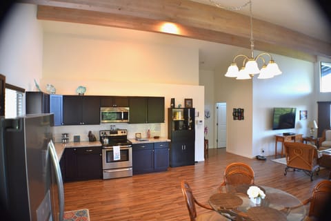 Modern kitchen with dining and desk nook.