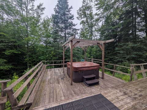 View from back sliders of private deck with hot tub in the back