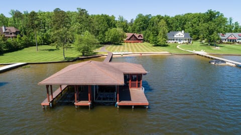 Our boat house with our home in the background as seen from above the lake
