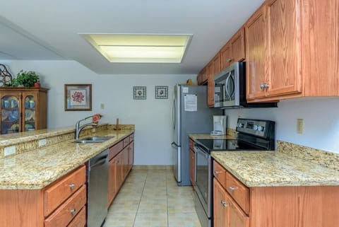 Kitchen with a stove, microwave, dishwasher, and a French door refrigerator