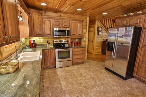 Gourmet kitchen with granite counter tops, coffee maker, and dishwasher