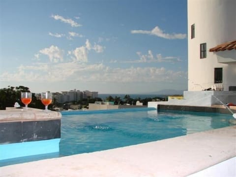 Pool with  jacuzzi sits in the courtyard.