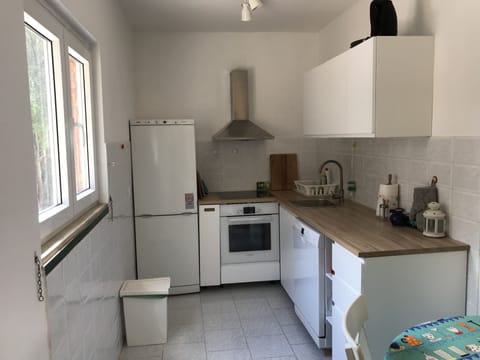 Kitchen with full size refrigerator, stove, oven, sink & dishwasher.  