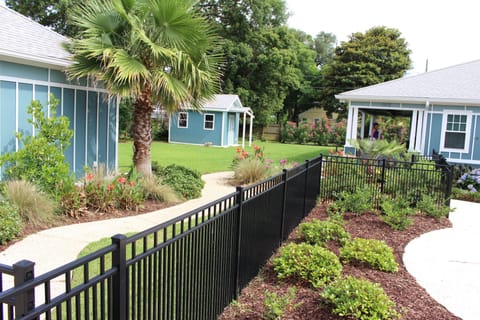 Property completely fenced in.  Garage on left; storage shed and main home
