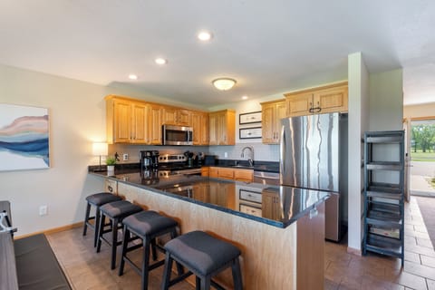 Full-sized kitchen, stocked with pots, pans, dishes, & utensils