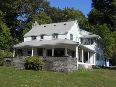 Original stone patio stretches along side of house