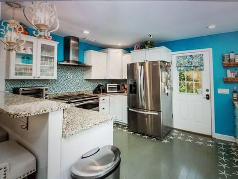 Big fridge and stove with vent and tons of cabinets. Door goes to back deck.