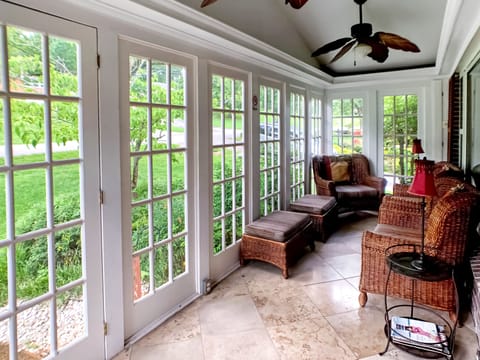 Enjoy your morning coffee or a glass of wine on the glassed-in front porch