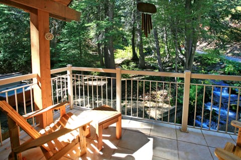 Cozy deck off Master overlooks the rushing stream and into the firs