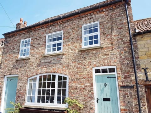 The stunning Coach House,  side walkway to garden and storage through left door.