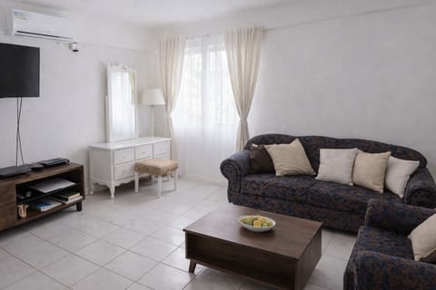 Bright, comfortable living space with air-conditioning and relaxed seating.
