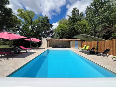 Relax on the spacious terrace by the heated pool + covered pool house seating